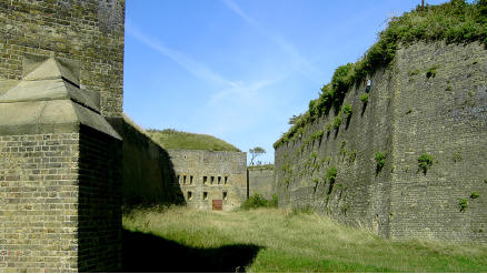 The ditch of the Drop Redoubt.  One of the four large caponiers added in the 1860s can be seen in the distance.  The caponiers allowed a clear line of fire on any enemy soldiers in the ditch.