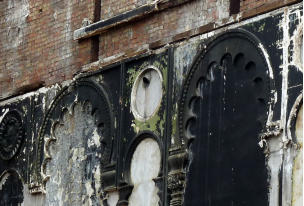 Demolition, August 2014. A detail of the moorish molding on the auditorium walls. The black paint from the night club years is peeling back to show the green of the original colour scheme.